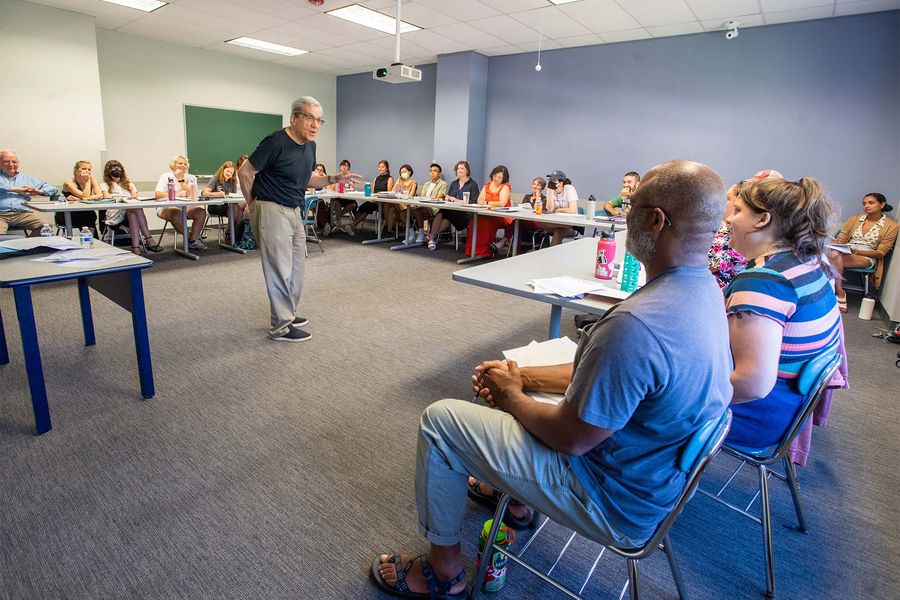 A group of teachers listening to a lecture.