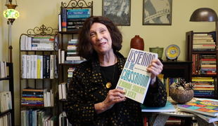 Shows Marnie Reed holding the book Listening in the Classroom