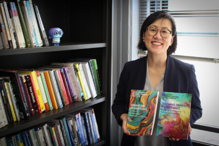 Photo of Grace Kim holding two books