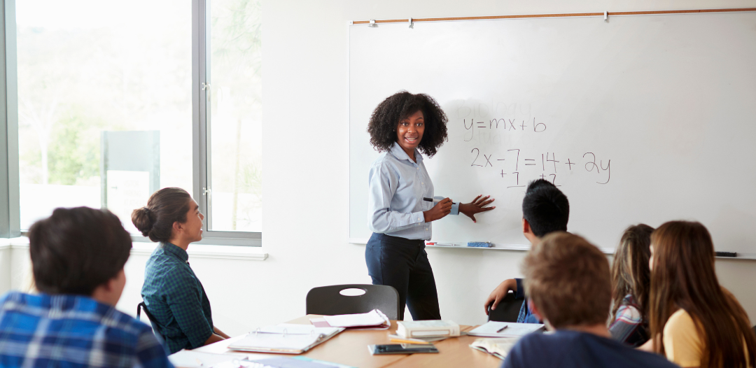 female teacher reviewing math terms with students