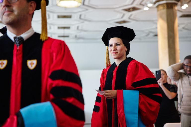 Female Doctoral Student at hooding ceremony