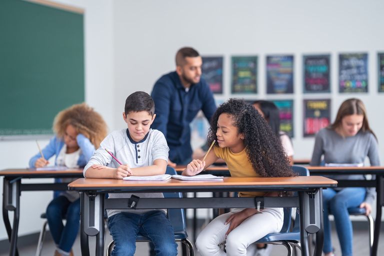 A photo of some elementary-aged students sitting at their desks and working.