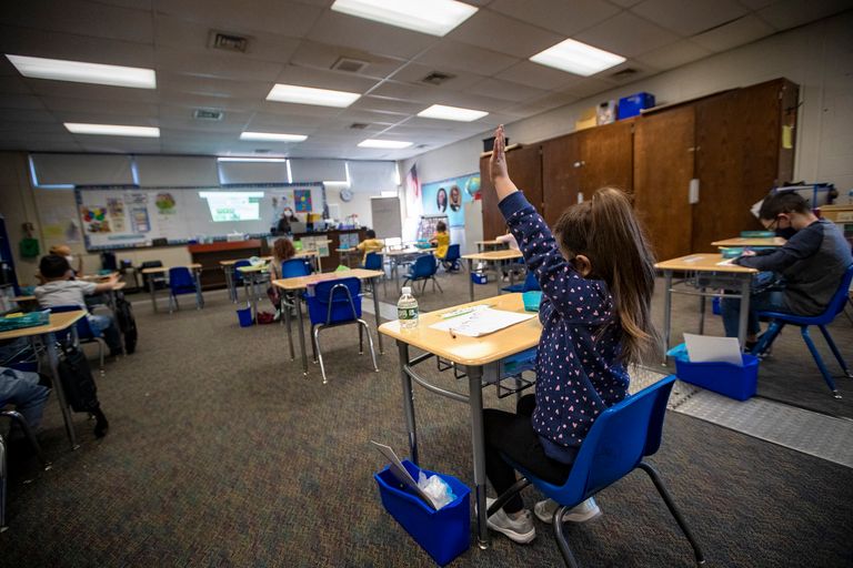 A student of Carmen Rios’ kindergarten class raises her hand during an English lesson at Barbieri Elementary School in Framingham. (Jesse Costa/WBUR)