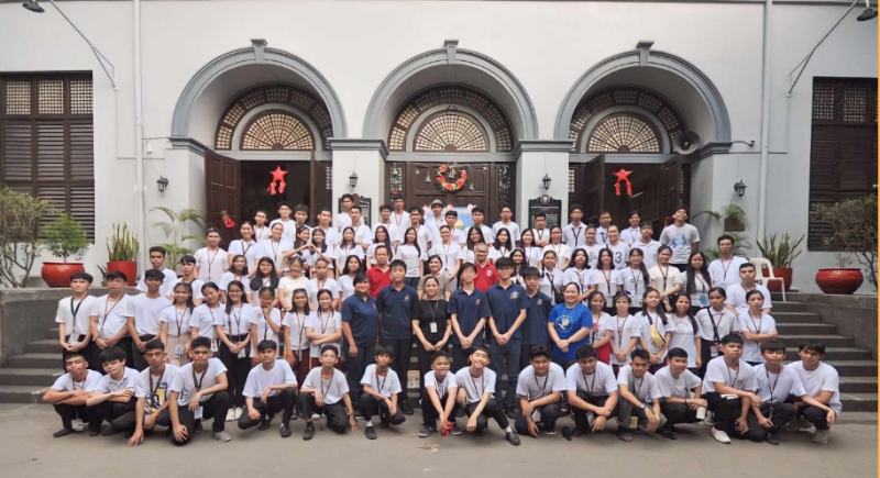 Photo of a group of students outside a school building.