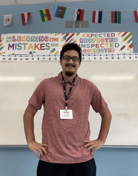 Shows Vincent Semidey standing at the front of a classroom