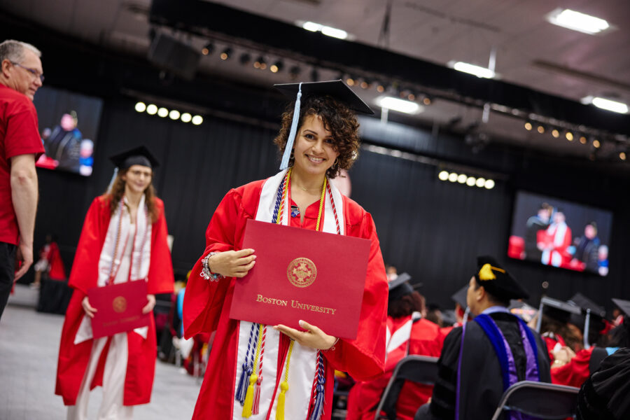 Joana Love smiling at the camera after she received her diploma at that 2024 BU Wheelock Convocation