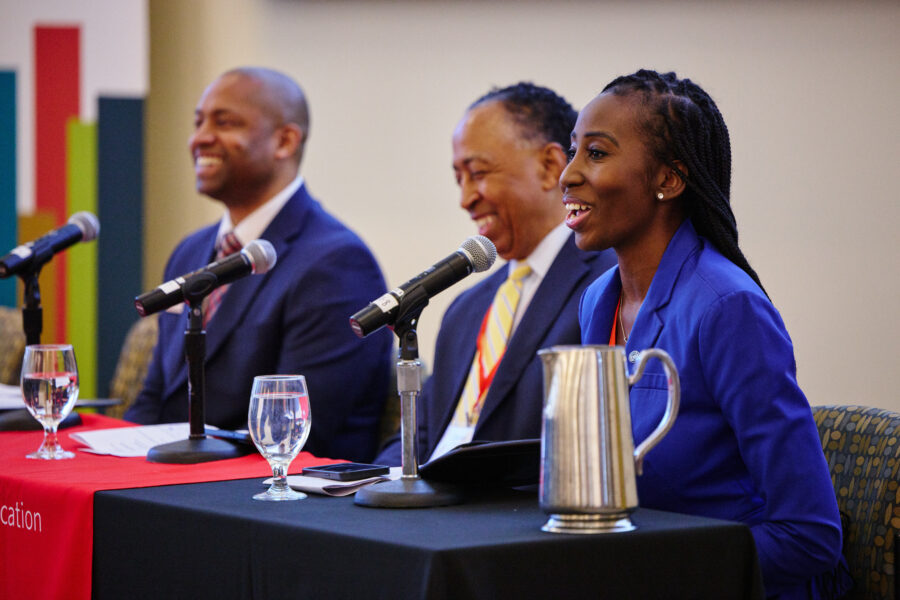 Three panelist smiling from left to right obert Lowe, General Dennis Via, Ret. , Tanesha Beckford