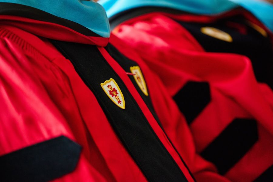close up photo of red BU doctoral robes