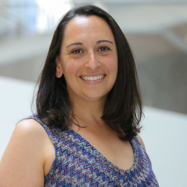 Photo of Rosie Norman, who is wearing a blue patterned sleeveless top.