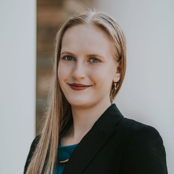 Shows Katherine Szocik who has long blond hair and is wearing a dark jacket