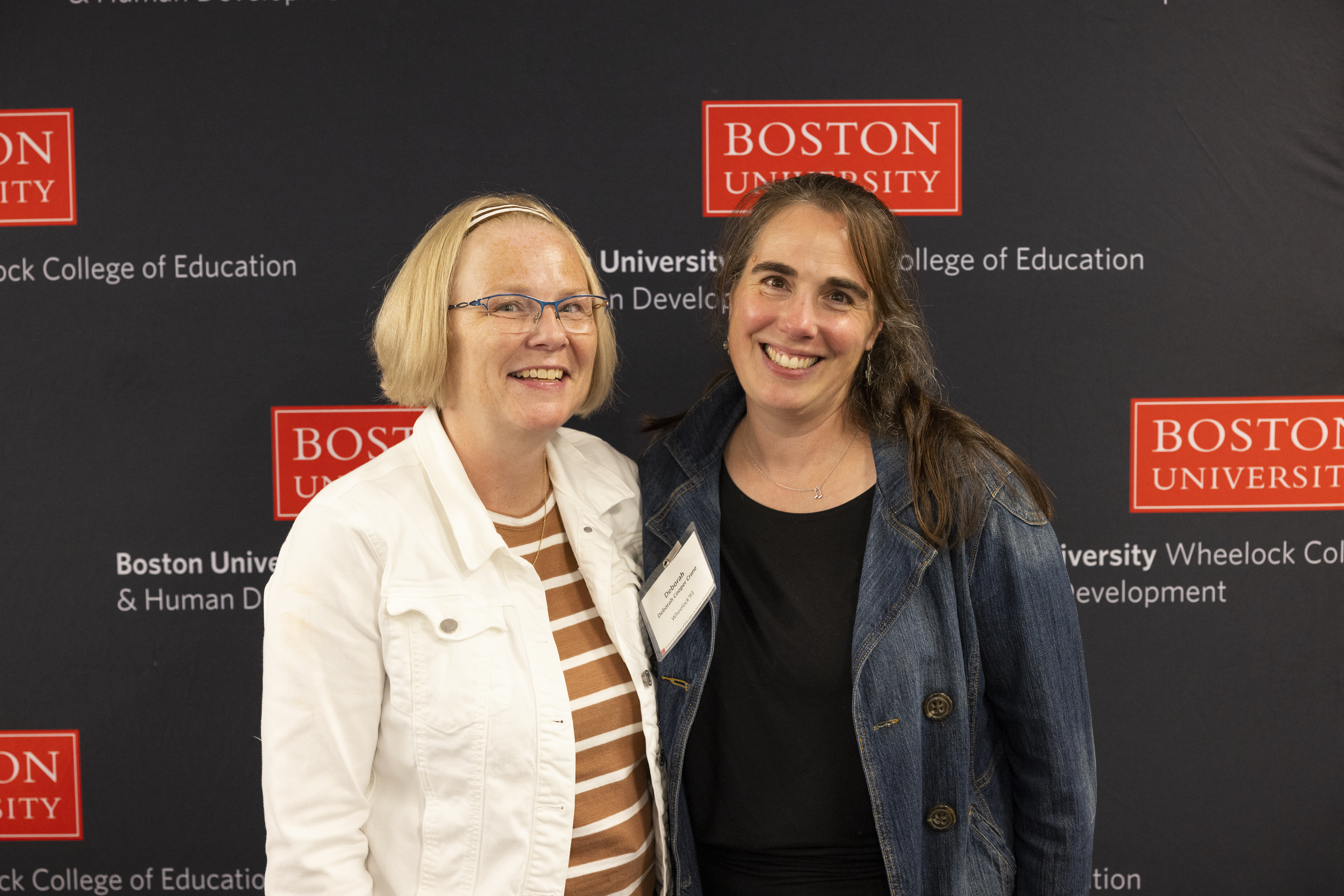 Two Wheelock Alums smiling at camera