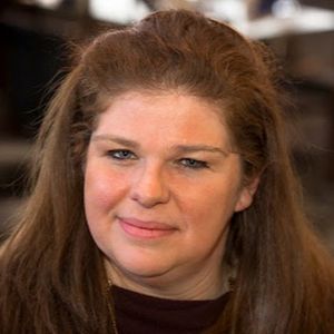 Shows Brenda LeBlanc Jaster, shoulder length reddish hair and dark reddish top