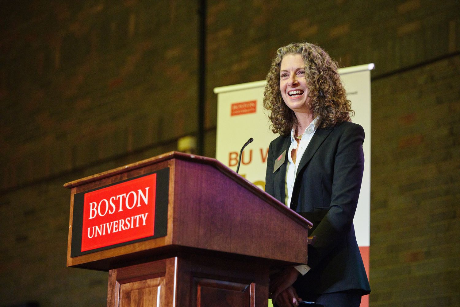 Dean Penny Bishop smiling at podium