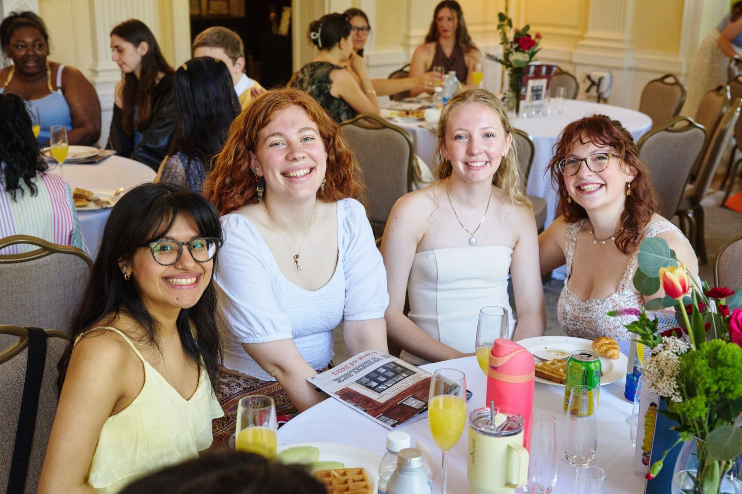 Shows four women sitting at a table