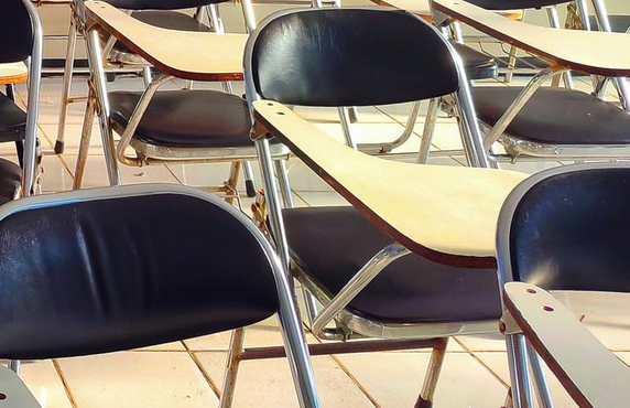Shows empty classroom chairs