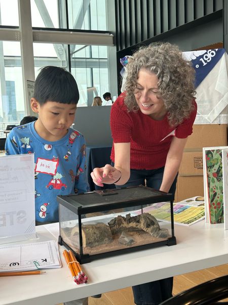 Dean Bishop learning with a young student about beetle survival