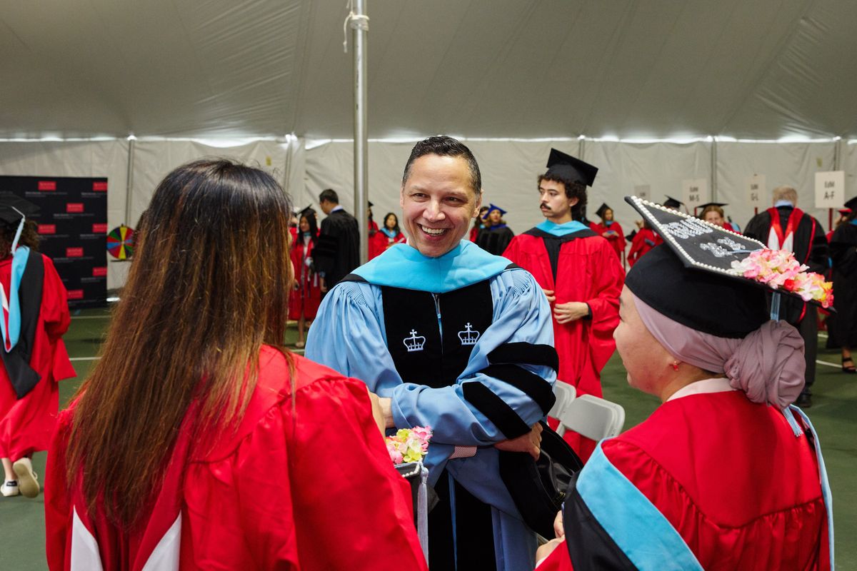 Educational Leadership and Policy Studies faculty member Ramon Gonzalez speaks with two recent graduates at BU Wheelock's convocation 2025