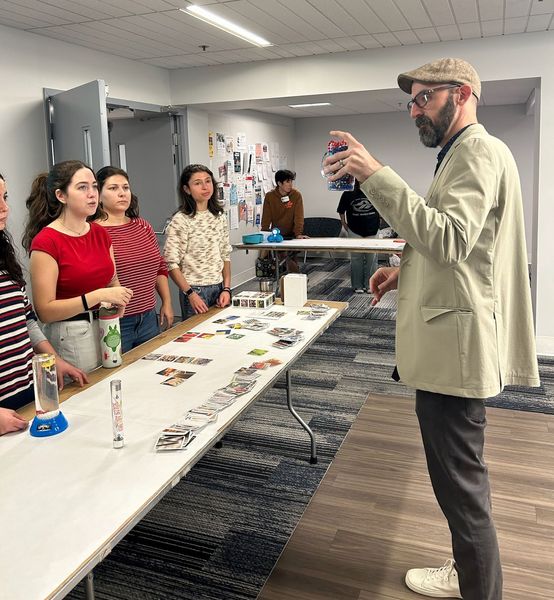 A teacher demonstrates a STEM related concept for a group of students
