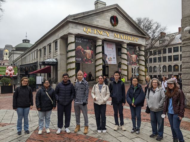 international students and faculty stand in front of a decorated Quincy Market