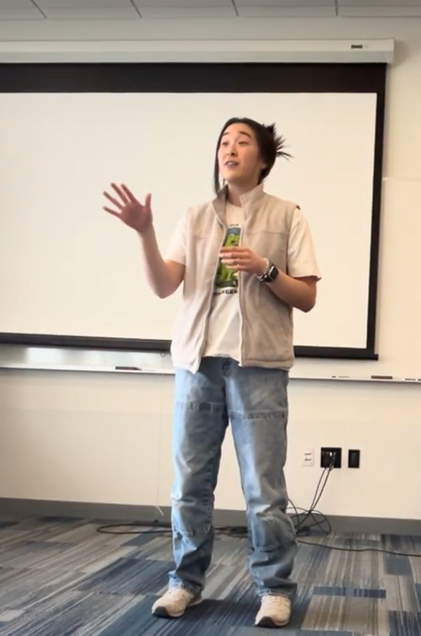 student delivering a speech in front of a whiteboard